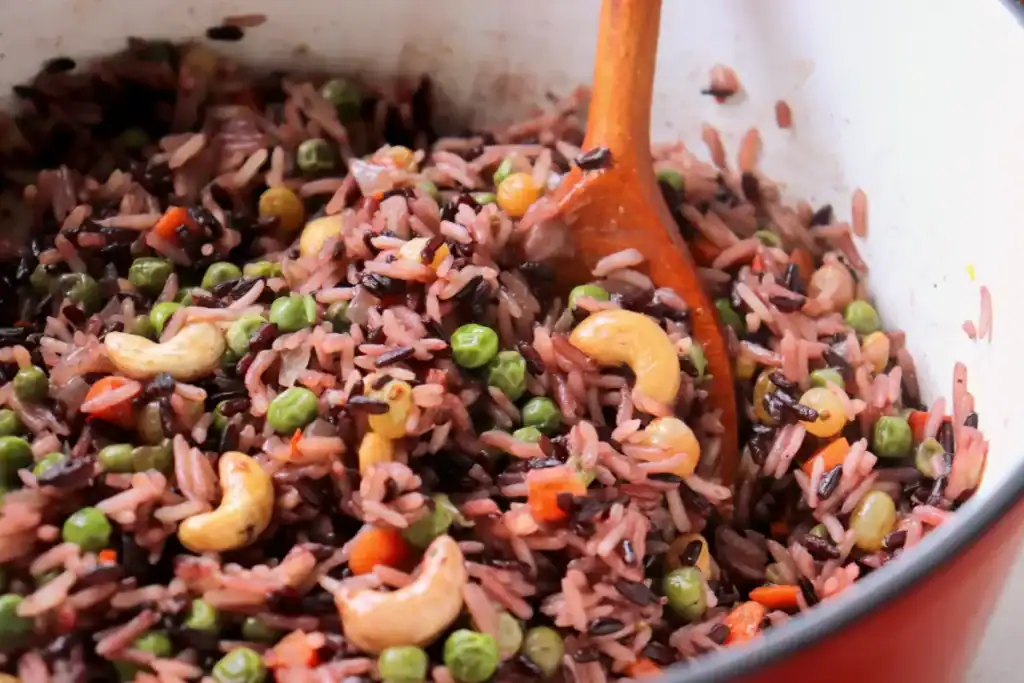 Dutch oven filled with warm, nutty rice pilaf ready to serve