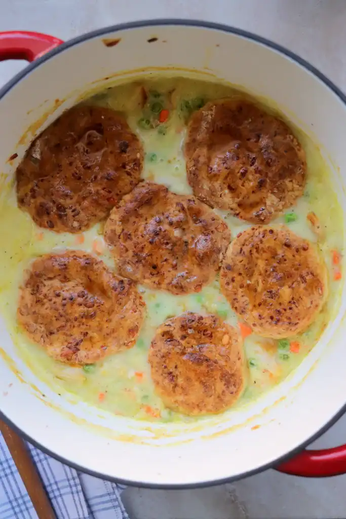 One-pot chicken pot pie in a Dutch oven with puff pastry or biscuit topping.

