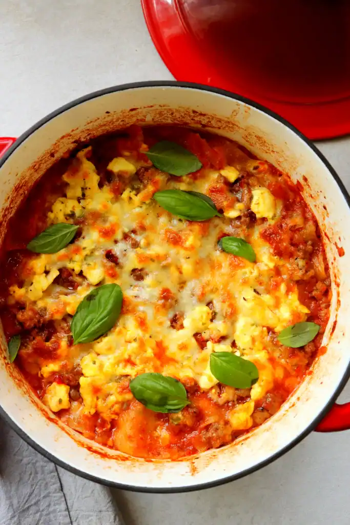 A pan with meat and cheese in it.