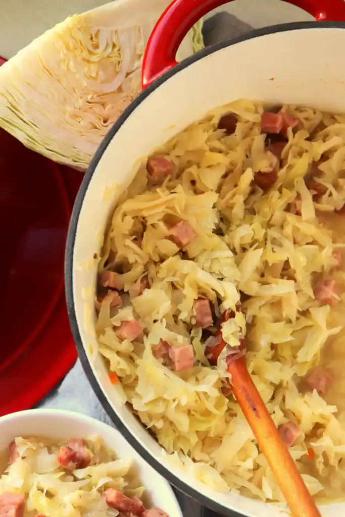 One-pot Dutch oven cabbage with smoky sausage and rich flavor.