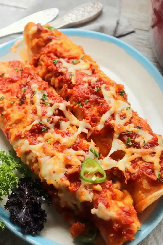 Close-up of Dutch oven enchiladas with black beans, corn, and peppers.