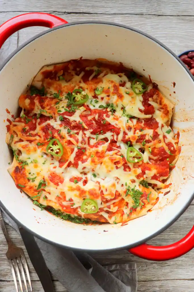 Cheesy Dutch Oven Vegetarian Enchiladas with Black Beans